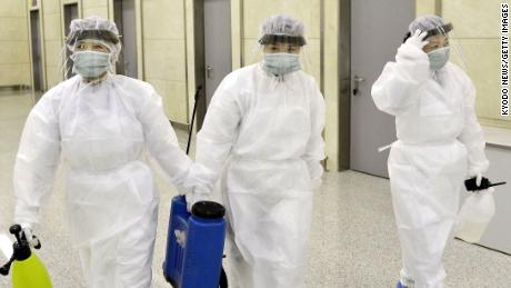 Quarantine staff in protective gear are pictured at Pyongyang International Airport on Saturday.