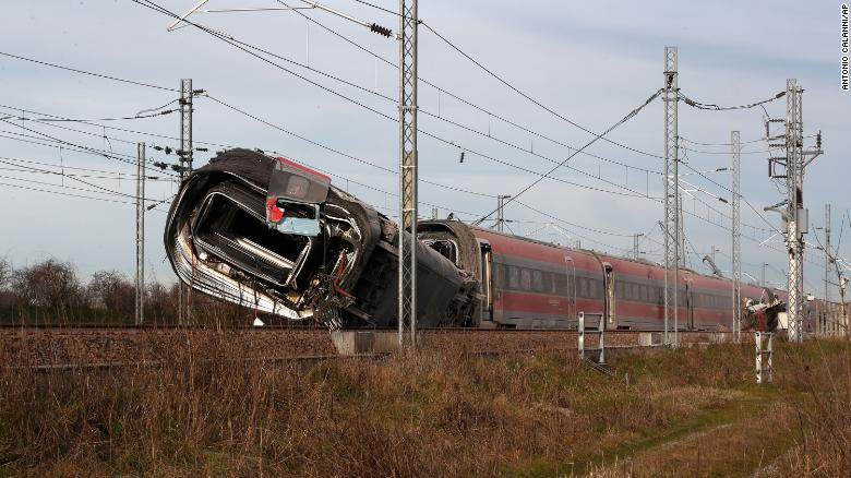 A train carriage lies on it side after derailing near Lodi in northern Italy.