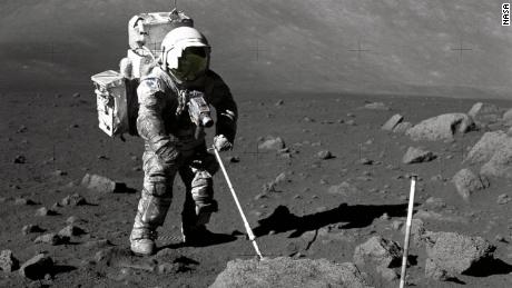 Astronaut Harrison Schmitt retrieves lunar samples during Apollo 17.