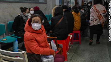 People wait for medical attention at Wuhan Red Cross Hospital in Wuhan on January 25, 2020. 