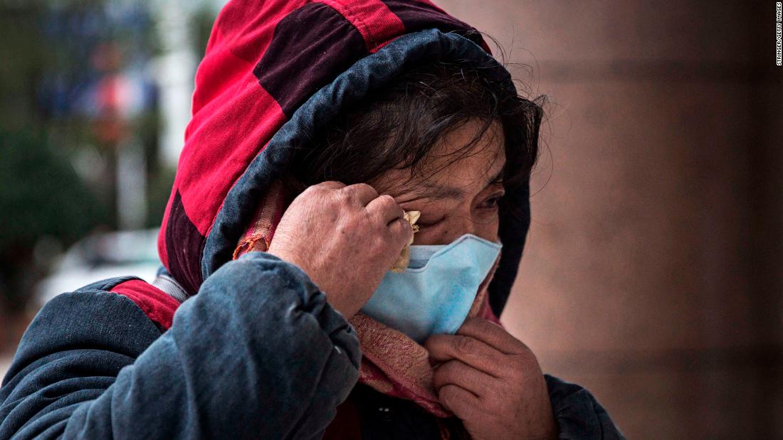 A woman grieves while paying tribute to Li at Li&#39;s hospital in Wuhan.