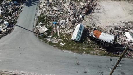 Wrecked vehicles, boats and piles of debris line streets in Marsh Harbor, Bahama.