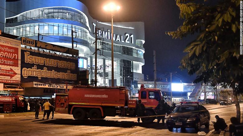 Thai soldiers and paramedics gather outside the Terminal 21 shopping mall where dozens of terrified shoppers were evacuated amid a manhunt for a mass shooting suspect.