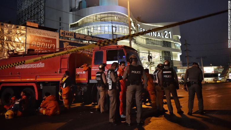 Police and firefighters stand outside the Terminal 21 shopping mall, where a mass shooting took place, in the Thai northeastern city of Nakhon Ratchasima on February 9.