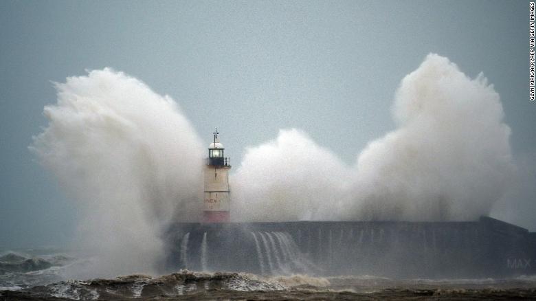 Waves crash over a lighthouse on the south coast of England on February 9, 2020, as Storm Ciara hits the UK. 