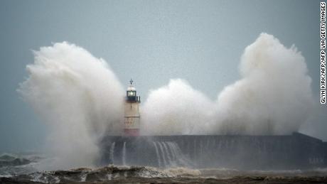 Waves crash over a lighthouse on the south coast of England on February 9, 2020, as Storm Ciara hits the UK. 