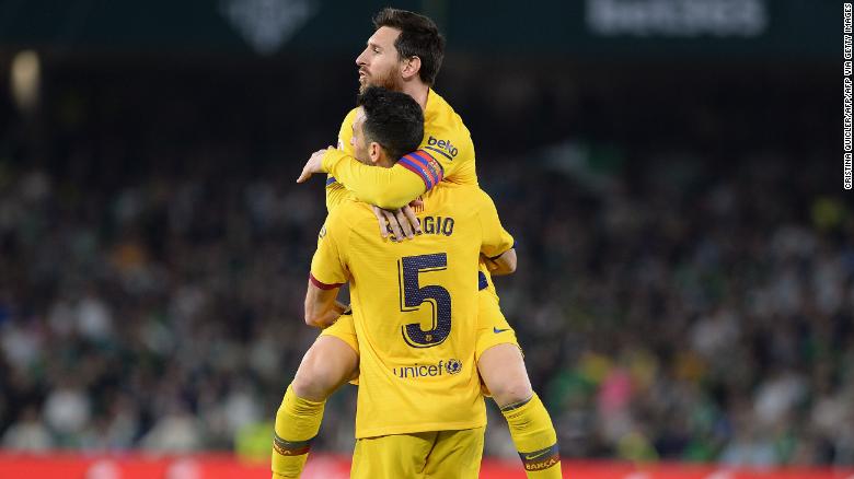 Sergio Busquets holds Messi aloft after equalizing for Barcelona.