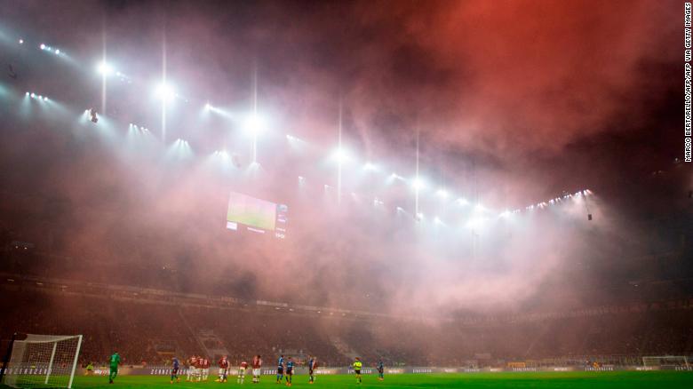 AC Milan&#39;s supporters light smoke bombs during the dramatic derby. 