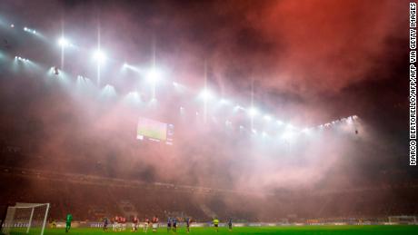 AC Milan&#39;s supporters light smoke bombs during the dramatic derby. 