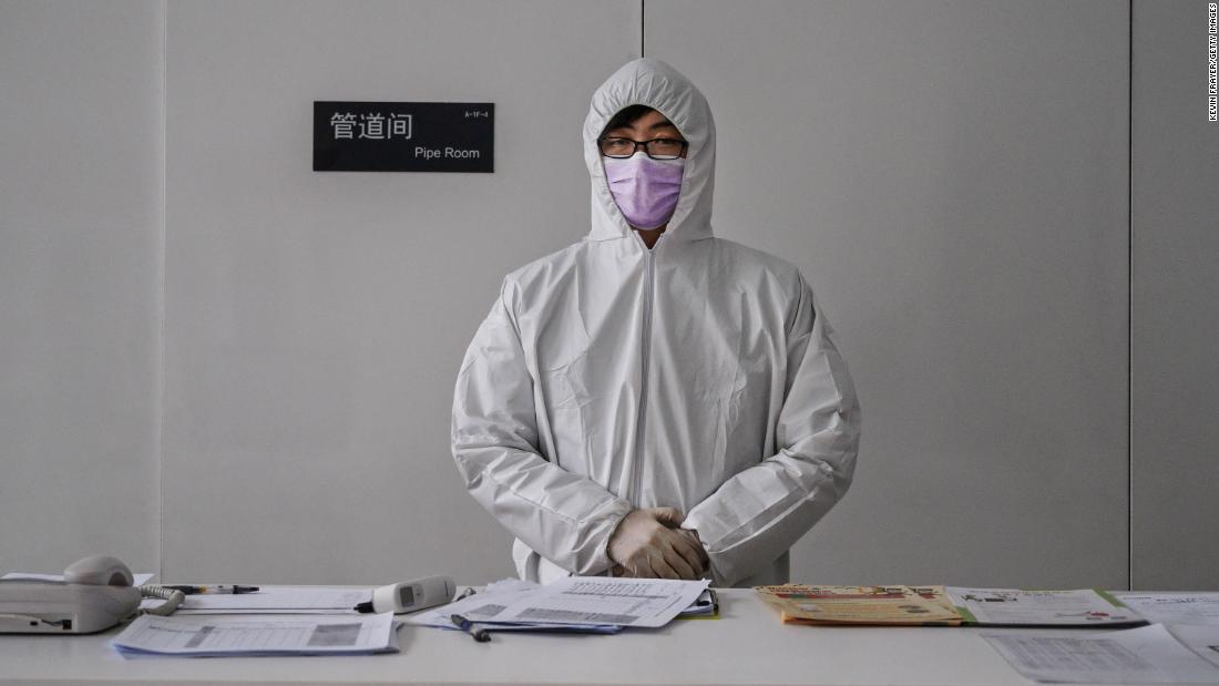 A worker wears a protective suit as he waits to screen people entering an office building in Beijing. China&#39;s workforce was &lt;a href=&quot;https://edition.cnn.com/2020/02/10/business/china-companies-return-to-work-coronavirus/index.html&quot; target=&quot;_blank&quot;&gt;slowly coming back to work&lt;/a&gt; after the coronavirus outbreak forced many parts of the country to extend the Lunar New Year holiday by more than a week.