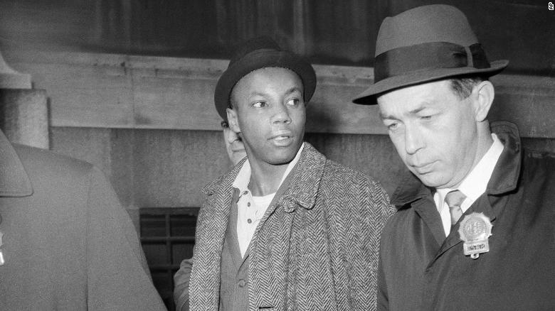 Norman 3X Butler is escorted by police after his arrest in New York on February 26, 1965.