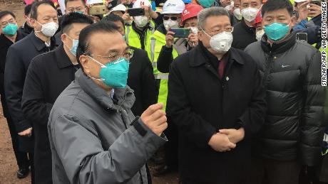 Chinese Premier Li Keqiang speaks as he visits a construction site of a new hospital being built to treat patients of a deadly virus outbreak in Wuhan in China&#39;s central Hubei province on January 27.