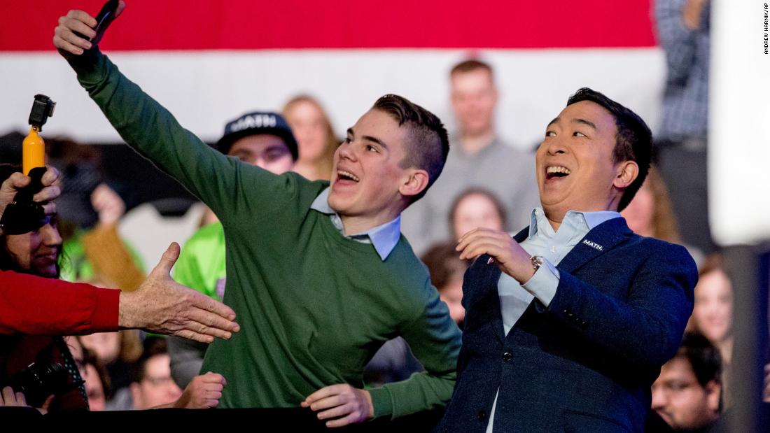 Yang takes a photo with an audience member as he arrives at an &quot;Our Rights, Our Courts&quot; forum in Concord, New Hampshire, in February 2020.