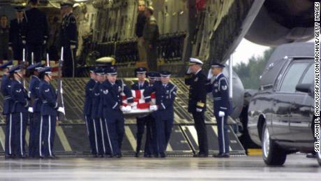 The remains of a sailor killed in the USS Cole attack are carried from a US Air Force transport plane on October 13, 2000 at Ramstein Air Force Base in Germany. 
