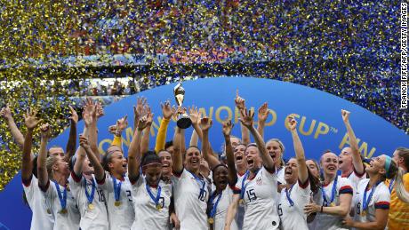 TOPSHOT - USA&#39;s players celebrate with the trophy after the France 2019 Womens World Cup football final match between USA and the Netherlands, on July 7, 2019, at the Lyon Stadium in Lyon, central-eastern France. (Photo credit should read FRANCK FIFE/AFP via Getty Images)