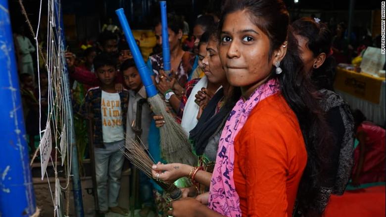Aarti Shiv cleans an artificial cobweb meant to symbolize taboos and stigma around periods during Maasika Mahotsav in Banjara Basti, India, on May 25, 2019.