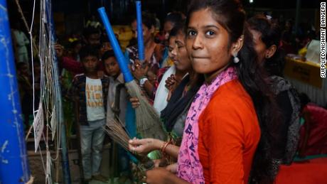 Aarti Shiv cleans an artificial cobweb meant to symbolize taboos and stigma around periods during Maasika Mahotsav in Banjara Basti, India, on May 25, 2019.