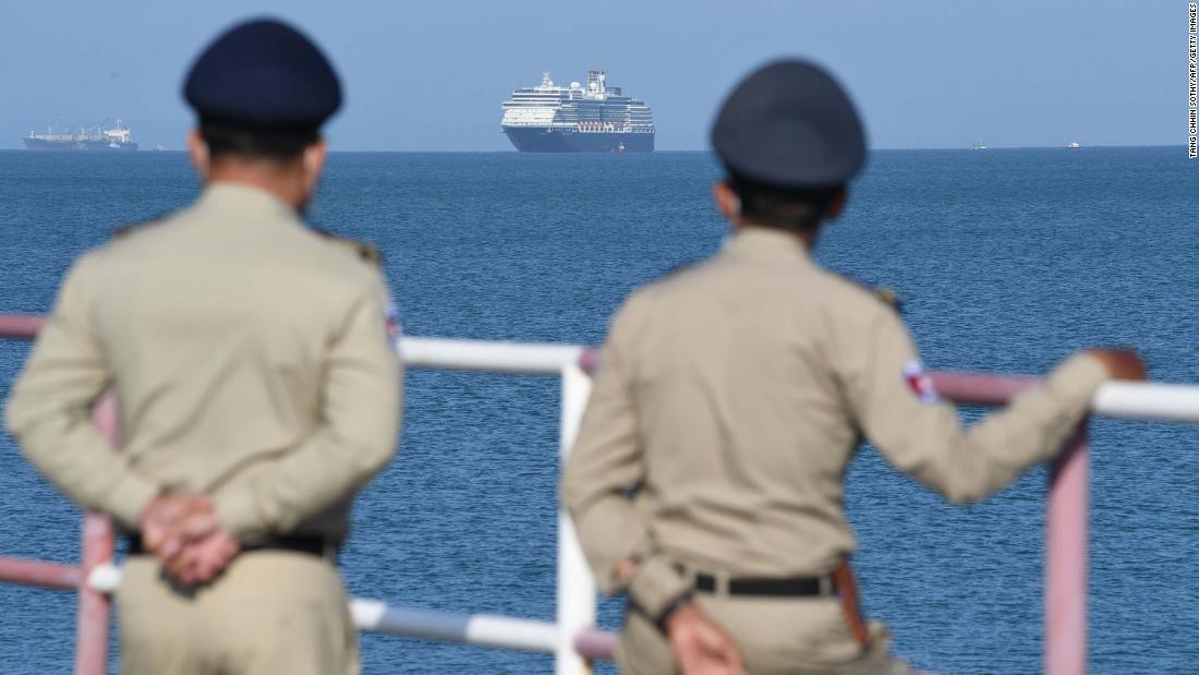 Authorities watch as the Westerdam cruise ship approaches a port in Sihanoukville, Cambodia, on Thursday, February 13. Despite having no confirmed cases of coronavirus on board, the Westerdam was refused port by four other Asian countries before being allowed to dock in Cambodia.