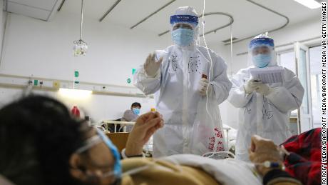 Medical personnel check the conditions of patients in Jinyintan Hospital, designated to treat coronavirus patients, in Wuhan.