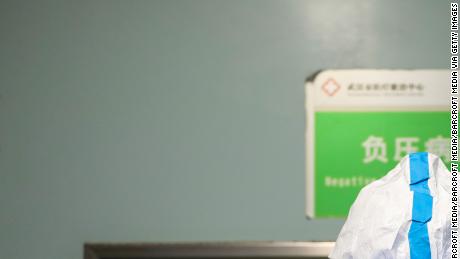 A doctor puts on the isolation outfit before entering the negative-pressure isolation ward in Jinyintan Hospital in Wuhan.