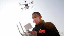 A local resident using a drone spraying disinfectant at a village in China&#39;s central Henan province in January.