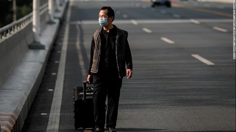 A man wears a protective mask as he walks in Wuhan on February 13, 2020.