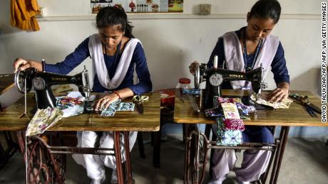 Indian students make reusable cloth sanitary napkins on Menstrual Hygiene Day in Guwahati on May 28, 2019. 