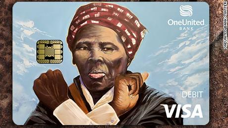 The new visa debit card from OneUnited Bank shows Harriet Tubman doing the sign language gesture for love. 