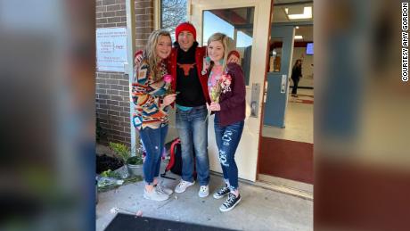 Wooley handed out flowers to every girl at his high school, including Kennedi Sherrill (right) and Meredith Short.