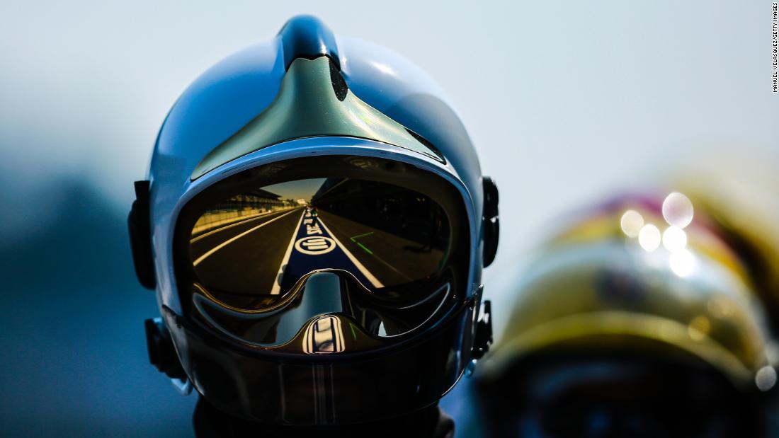 A helmeted fireman watches on as the race unfolds.