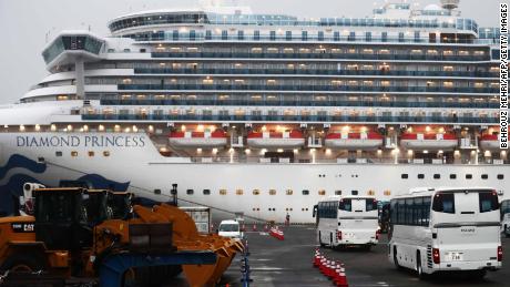 Two buses arrive next to the Diamond Princess cruise ship, with people quarantined onboard due to fears of the new coronavirus, at the Daikaku Pier Cruise Terminal in Yokohama port on February 16, 2020. - The number of people who have tested positive for the new coronavirus on a quarantined ship off Japan&#39;s coast has risen to 355, the country&#39;s health minister said. (Photo by Behrouz MEHRI / AFP) (Photo by BEHROUZ MEHRI/AFP via Getty Images)