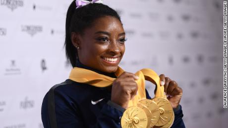 STUTTGART, GERMANY - OCTOBER 13: Simone Biles of USA poses with her Medal haul after the Apparatus Finals on Day 10 of the FIG Artistic Gymnastics World Championships at Hanns Martin Schleyer Hall  on October 13, 2019 in Stuttgart, Germany. (Photo by Laurence Griffiths/Getty Images)