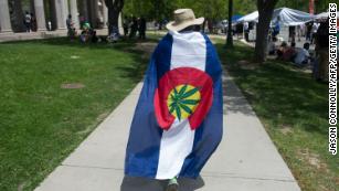 A man is draped in pro-marijuana colors during the Denver 420 Rally, the world&#39;s largest celebration of both the legalization of cannabis and cannabis culture, May 21, 2016 in Denver Coloroado. The western mountainous Colorado is one of four US states along with the District of Columbia that has legalized the use of recreational marijuana.       (Photo credit should read JASON CONNOLLY/AFP via Getty Images)