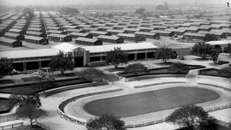 The Santa Anita Park race track is converted into an internment for evacuated Japanese Americans who will occupy the barracks erected in background.