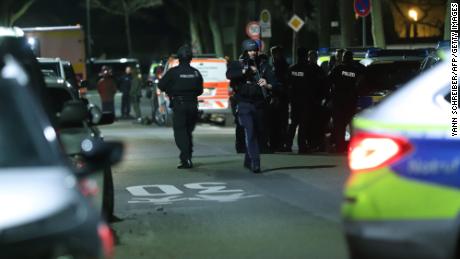 TOPSHOT - Police gather near the scene of a shooting in Hanau, western Germany, on February 20, 2020. - At least eight people were killed in two shootings late on February 19 near the German city of Frankfurt, with an unknown number of attackers still at large, police said. The shootings targeted shisha bars in Hanau, about 20 kilometres (12 miles) from Frankfurt, according to local media, and police launched a huge manhunt in the town of around 90,000 people. (Photo by Yann Schreiber / AFP) (Photo by YANN SCHREIBER/AFP via Getty Images)