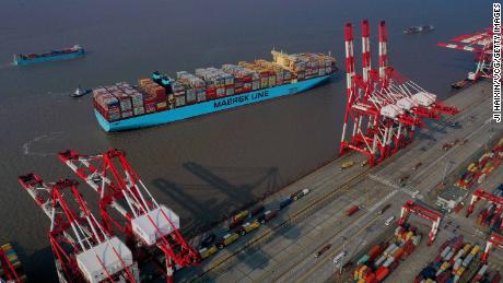 Tugboats guide a Maersk container ship in Shanghai.