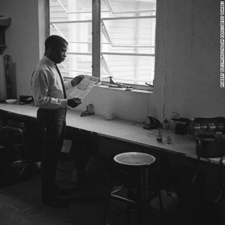 View of American Civil Rights activist (and future politician) John Lewis, chairman of the Student Non-Violent Coordinating Committee (SNCC), in an office, New York, 1964. He reads a document entitled &#39;We Shall Overcome; the Authorized Record of the March on Washington Produced by the Council for United Civil Rights Leadership.&#39; (Photo by Robert Elfstrom/Villon Films/Getty Images)