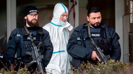 Police officers guard the entrance of a bar where several people were killed late Wednesday in Hanau, Germany.