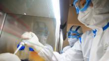 TOPSHOT - This photo taken on February 19, 2020 shows laboratory technicians testing samples of virus at a laboratory in Hengyang in China&#39;s central Henan province. - The death toll from the COVID-19 coronavirus epidemic jumped to 2,112 in China on February 20 after 108 more people died in Hubei province, the hard-hit epicentre of the outbreak. (Photo by STR / AFP) / China OUT (Photo by STR/AFP via Getty Images)