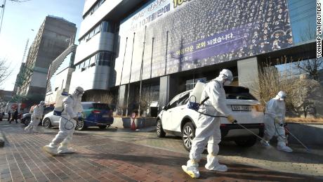 Employees of a disinfection service company disinfect a street outside a branch of the Shincheonji religious group in Daegu, South Korea on February 19.