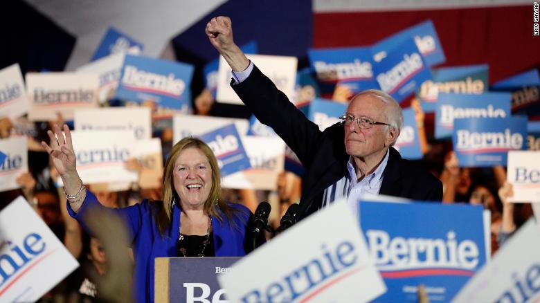 Democratic presidential candidate Sen. Bernie Sanders, I-Vt., right, with his wife Jane, raises his hand as he speaks during a campaign event in San Antonio, Saturday, Feb. 22, 2020.