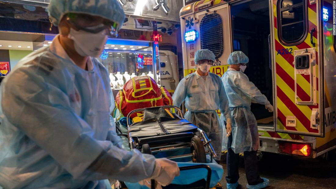 Paramedics carry a stretcher off an ambulance in Hong Kong on February 23, 2020.