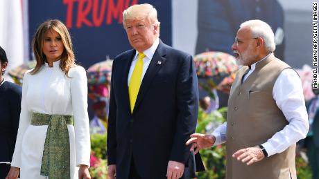 India&#39;s Prime Minister Narendra Modi (R) speaks with US President Donald Trump (C) and First Lady Melania Trump (L) upon their arrival at Sardar Vallabhbhai Patel International Airport in Ahmedabad on February 24, 2020.