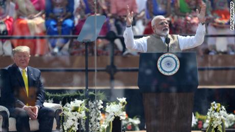 U.S. President Donald Trump, left, listens to Indian Prime Minister Narendra Modi at Sardar Patel Stadium in Ahmedabad, India, Monday, Feb. 24, 2020. India poured on the pageantry with a joyful, colorful welcome for President Donald Trump on Monday that kicked off a whirlwind 36-hour visit meant to reaffirm U.S.-India ties while providing enviable overseas imagery for a president in a re-election year. (AP Photo/Aijaz Rahi)