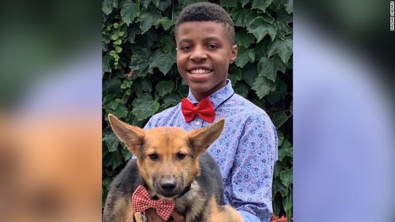 Sir Darius Brown poses with a dog wearing one of his original bow ties.