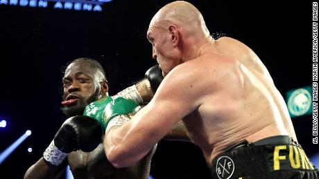 Fury (right) punches Wilder.