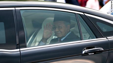 Malaysia's Prime Minister Mahathir Mohamad waves after he was granted an audience with King Sultan Abdullah Sultan Ahmad Shah at the National Palace in Kuala Lumpur, on Monday, Feb. 24, 2020. 