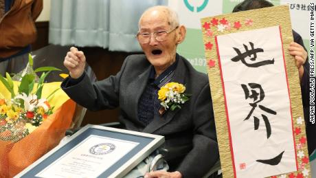 112-year-old Japanese man Chitetsu Watanabe poses next to calligraphy reading in Japanese &#39;World Number One&#39; after he was awarded as the world&#39;s oldest living male in Joetsu, Niigata prefecture on February 12.