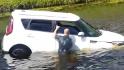 See bystanders rescue woman in sinking car
