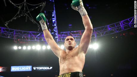 Fury celebrates after knocking down Deontay Wilder during their latest bout. 